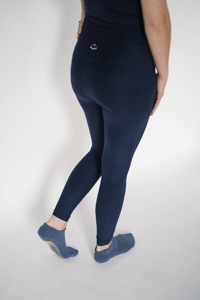 back of woman wearing beyond yoga navy leggings