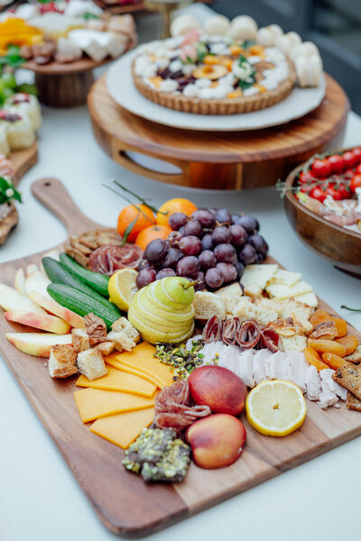 Charcuterie board with fruit, cheese, and meats