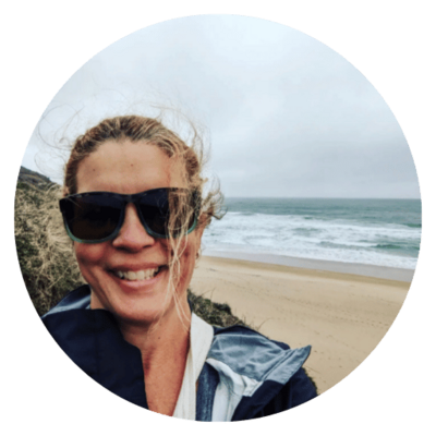 Happy leadership coach smiling on the beach