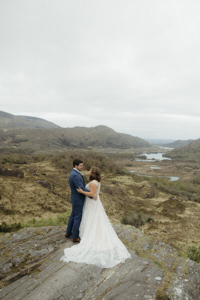 bride and groom standing on mountain in killarney ireland