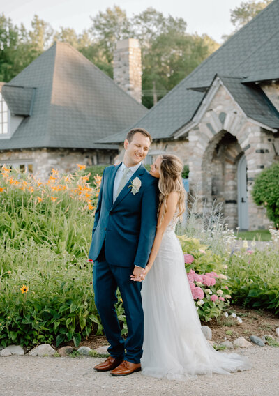 a newly married couple outside by a castle in Charlevoix with a Michigan wedding photographer