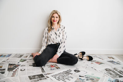 Sarah Klongerbo holding up a magazine page that she lit on fire