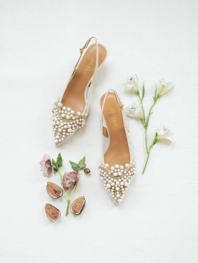 elegant wedding shoes next to figs