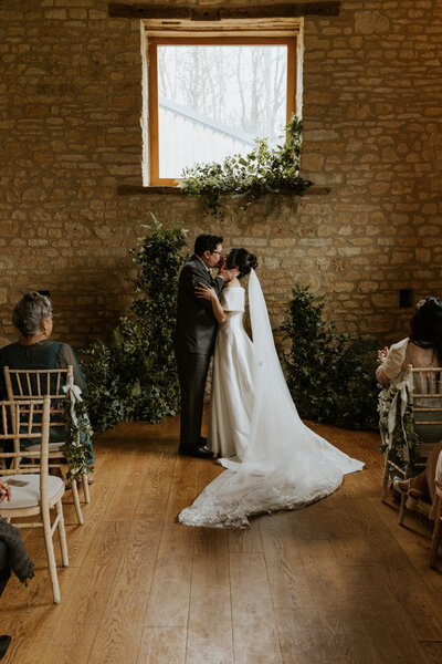 A couple sharing a heartfelt moment, exchanging vows during their intimate wedding ceremony.