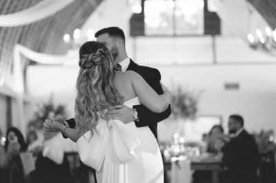 Bride and groom walking hand in hand towards camera