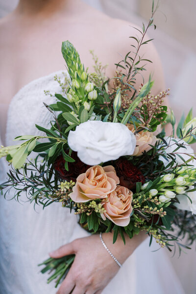 wedding florals held by the bride.