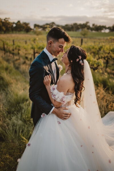 Man holding woman in his arms with horizon in the background