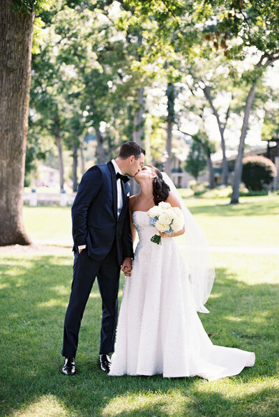 Newly Married Couple Embracing Outside Photo Taken by Emily Barbara a Wisconsin Wedding Photographer.