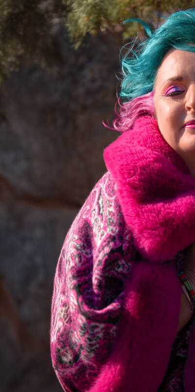 Yolandi Boshoff Yolandi Boshoff on a mountain in a pink jacket, half portrait, experiencing true freedom. 