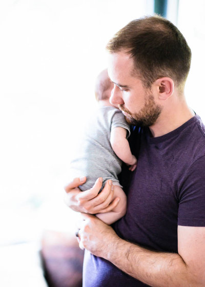 dad holding brand new baby