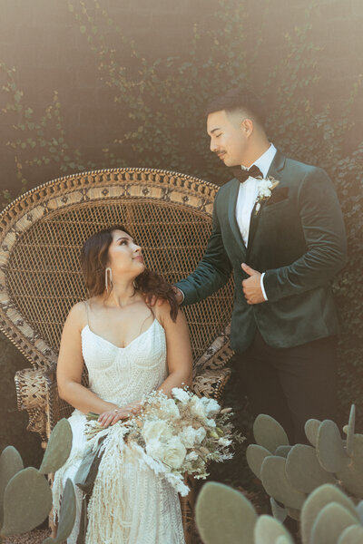romantic wife and groom with vintage peacock chair
