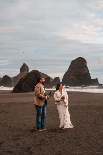 Bride and groom kissing in front of a waterfall along the Oregon Coast