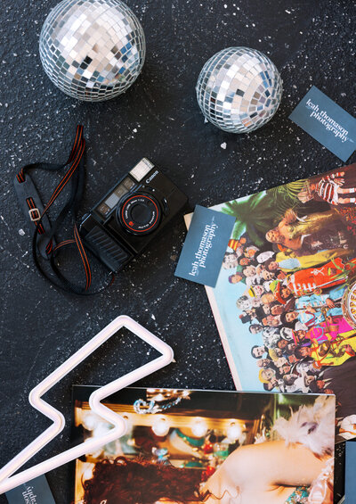 camera gear and records laid out with disco balls