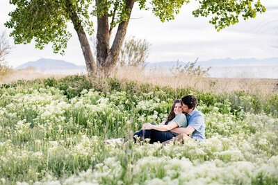 Man and woman sitting in wildflowers