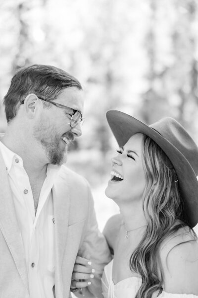 Bride and groom sharing a heartfelt laugh during their intimate elopement in Jackson, Wyoming, capturing their love and happiness in a breathtaking mountain backdrop.