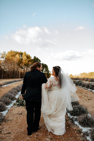 Bride and groom walking outside of Raleigh wedding