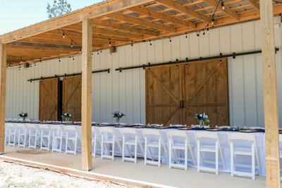 Outdoor reception setup at The Grove with farmhouse tables, elegant lighting, and western-modern décor.