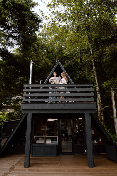 Bride holding up a bouquet of flowers during a beach elopement in Michigan.