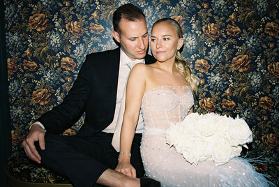 Bride and groom pose together post-ceremony at their reception venue.