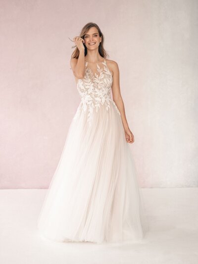 This gown's modified A-line silhouette accents curves while maintaining a full-skirted silhouette.