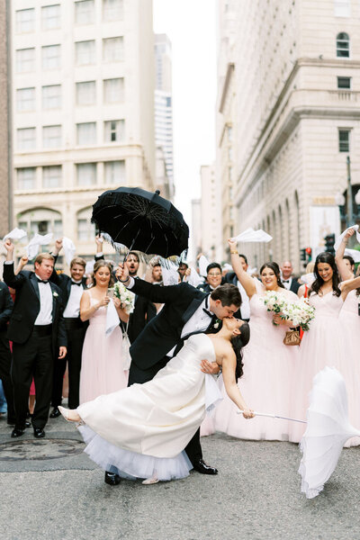Margaret and Nick and bridal party walking down street