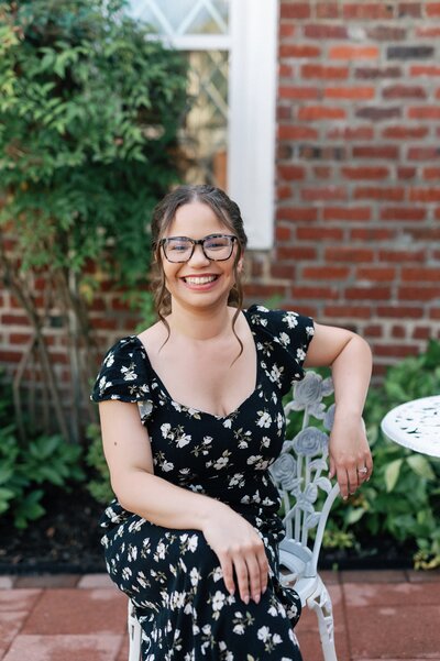 a woman in black and white dress sitting