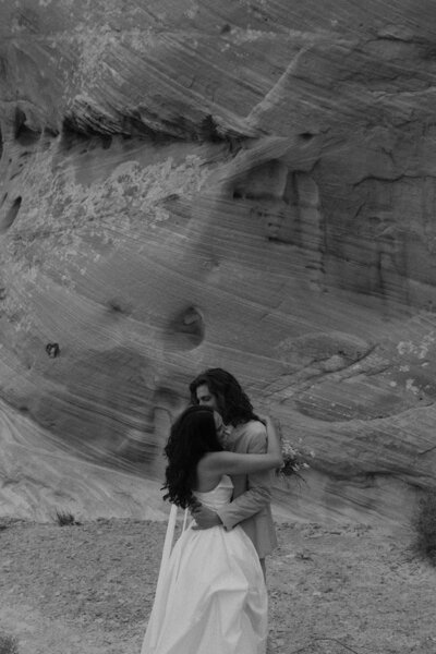 Bride and groom embracing at Amangiri