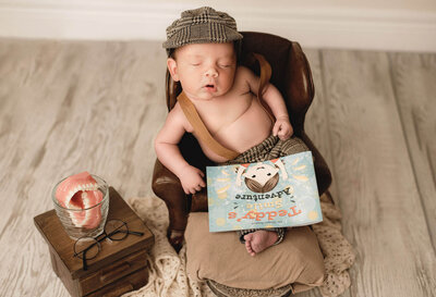 Greater Toronto Newborn Photography of a boy dressed in suspenders sitting in a chair with dentist props , by Tamara Danielle Photography