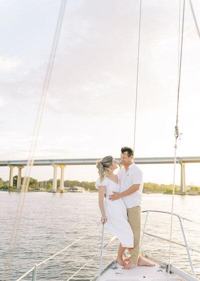 couple about to kiss on a sailboat