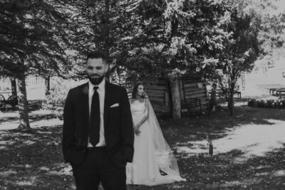 Black and white photo of bride and groom right before first look. Colorado fall wedding