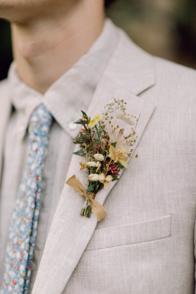 Groom standing confidently in a tailored suit in a Richmond backyard setting.
