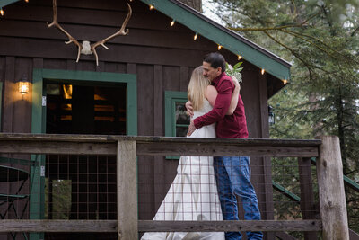 Bride and Groom hugging after first look on cabin deck.