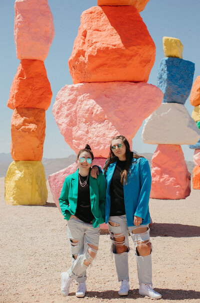 Two girls posing in front of rocks.