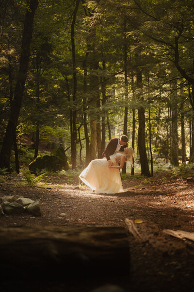 Dipping his new bride in the beaming sun during a Lake Placid Elopement.