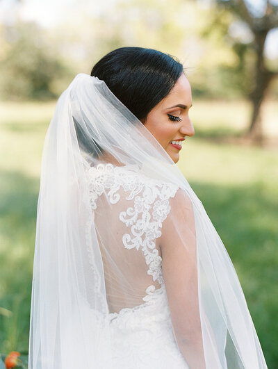 Portrait of bride with her veil around her shoulders