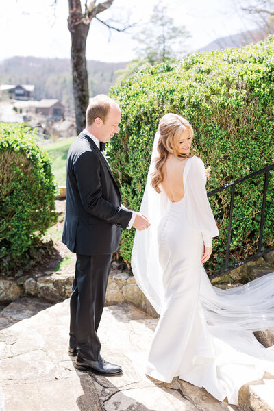 bride and groom sharing a first look at the william aiken house