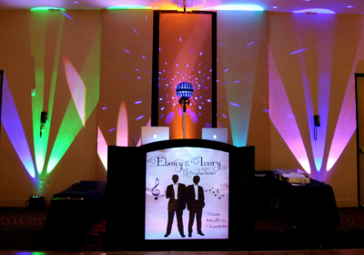 Envision an event facility with what was harsh lighting being showered in washes of fuchsia, lime green, rose,  light purple and a blanket of stars on the ceiling.