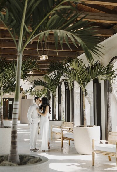 couple shares a kiss in south florida after wedding ceremony