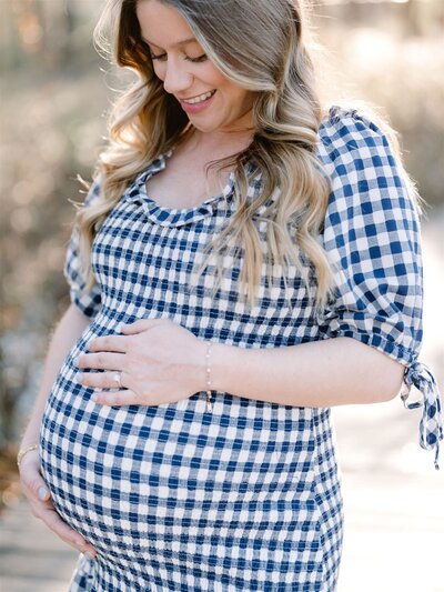 Couple smiling at each other, holding ultrasound photos