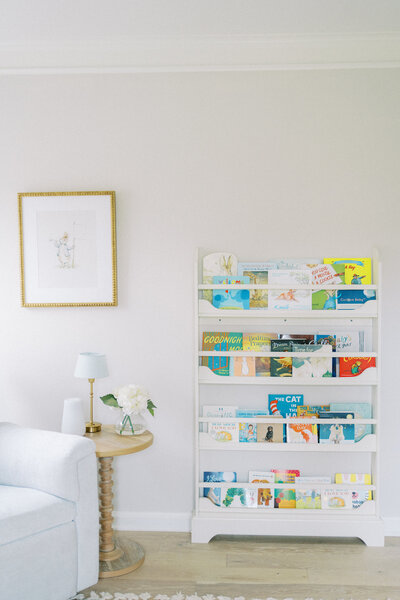 a colorful bookshelf in a baby nursery