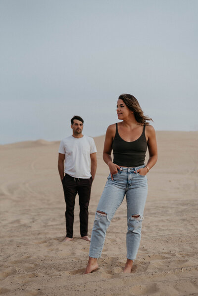 couple standing apart in dunes