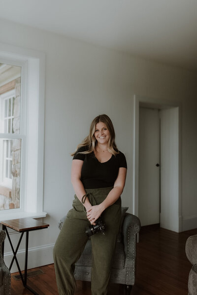 photo of wedding and boudoir photographer woman holding camera owner of mayberry and stone