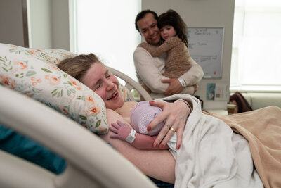 a mother holds her baby for the first time after giving birth.
