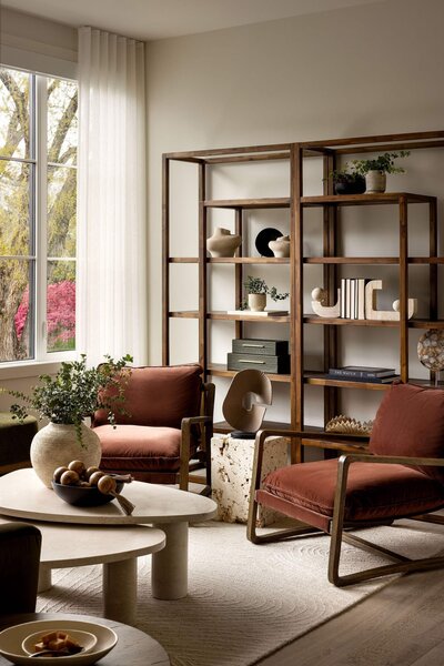 Japandi-style home library with rust and brown tones, custom bookshelf, and warm organic textures.