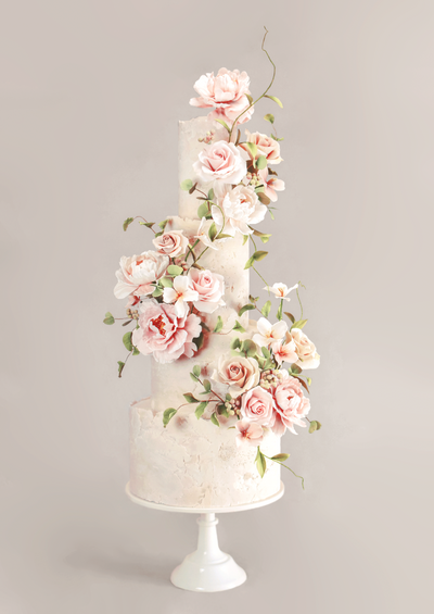 four tiered wedding cake with stone fondant and pale pink blousy sugar blooms