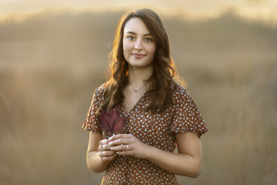 Highschool senior photoshoot girl in field golden sunlight fine art outdoor senior portrait