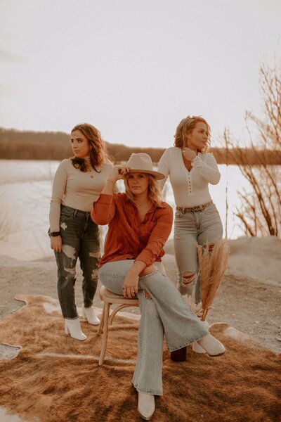 Jena, Brittany, and Emily sitting in the desert.