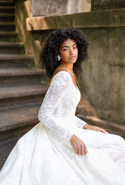 A bride. sitting on the steps at the Swan House in Atlanta, GA