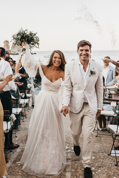 Photo of bride and groom walking down the aisle