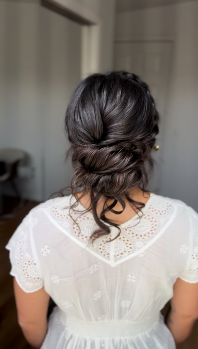 Bride with a textured, messy low bun — relaxed and romantic bridal style by Klover Beauty in Maryland.